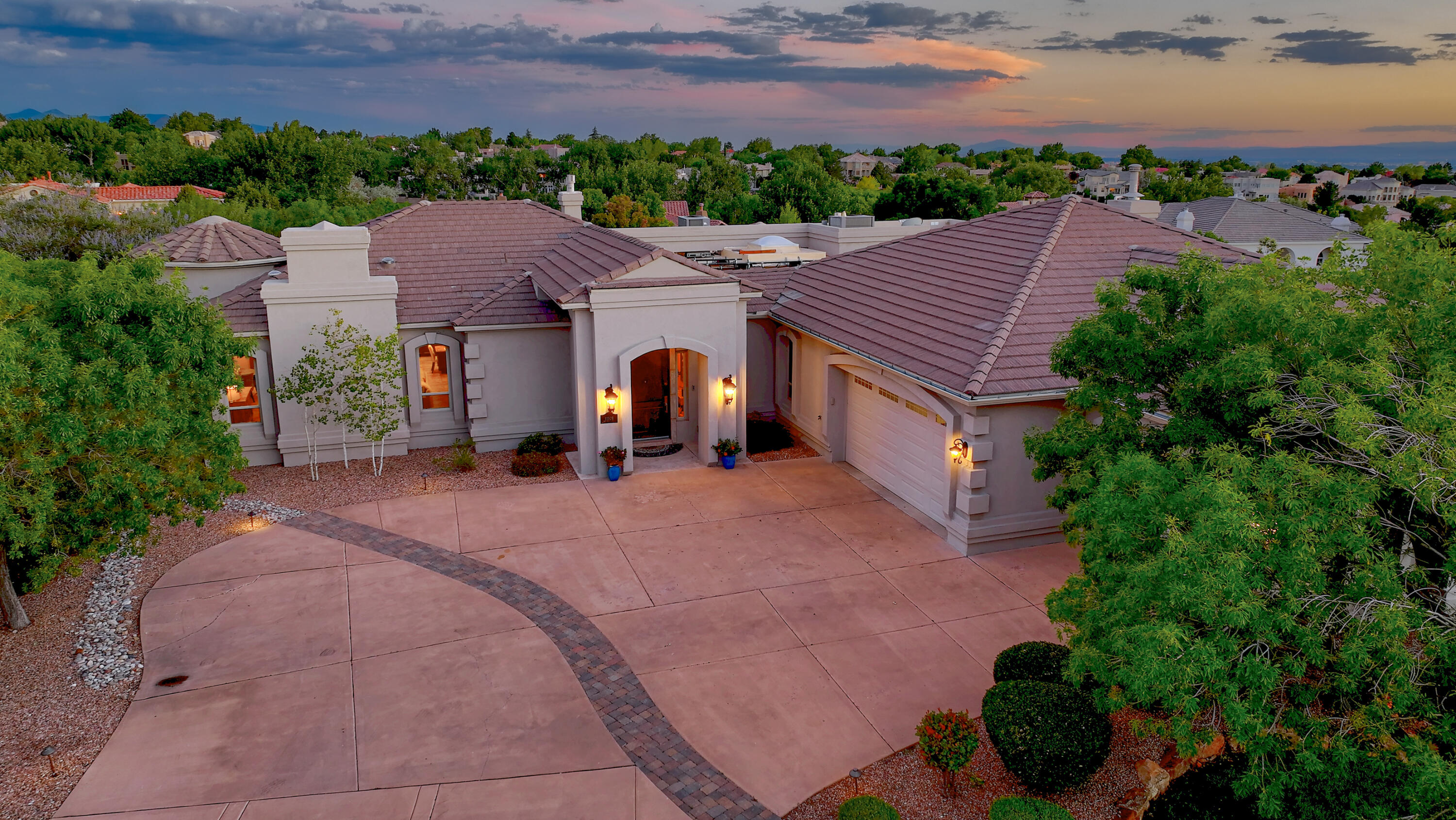 This elegant estate overlooks the Tanoan golf course, and enjoys fabulous Sandia mountain views, all within the gated Sauvignon community. Updated throughout with a Control 4 Smart Home System, 10kW solar power, central air PLUS radiant heat with leak detection, four zones of refrigerated air.  The home offers a fabulous projection theater room, a library, and an indoor saltwater pool with commercial grade temperature and humidity control and moisture grade walls. Tankless water heater, reverse osmosis, and water softener.  Five fireplaces including one with the outdoor kitchen.  Luxurious master suite with two walk-in closets, jetted tub, and fireplace.  This home has a downstairs game/living room  that could also serve as an in-law quarters.  10 year warranty on new synthetic stucco.