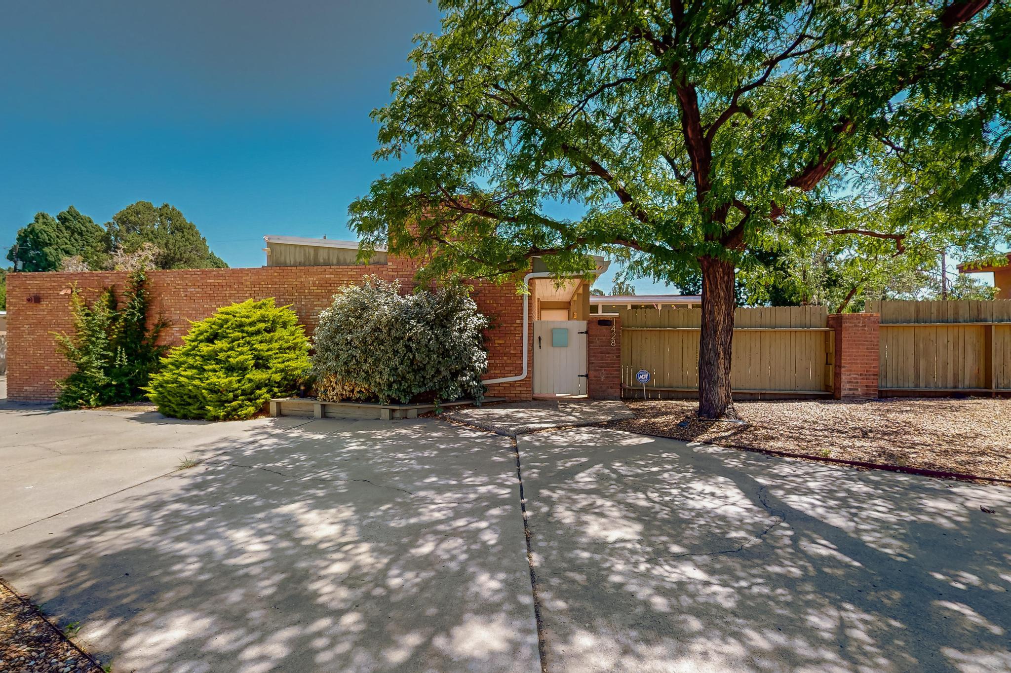 Your chance to own a piece of Mid-Century Modern history in the Vista Larga historic district, an Albuquerque gem of a neighborhood. Incredible single level custom home on private lot (1/4 acre), near UNM golf course,). Filled with character & coziness, this spacious floor-plan with three living spaces .834 SQ FT Guest Quarters has a spacious bedroom overlooking the back patio.