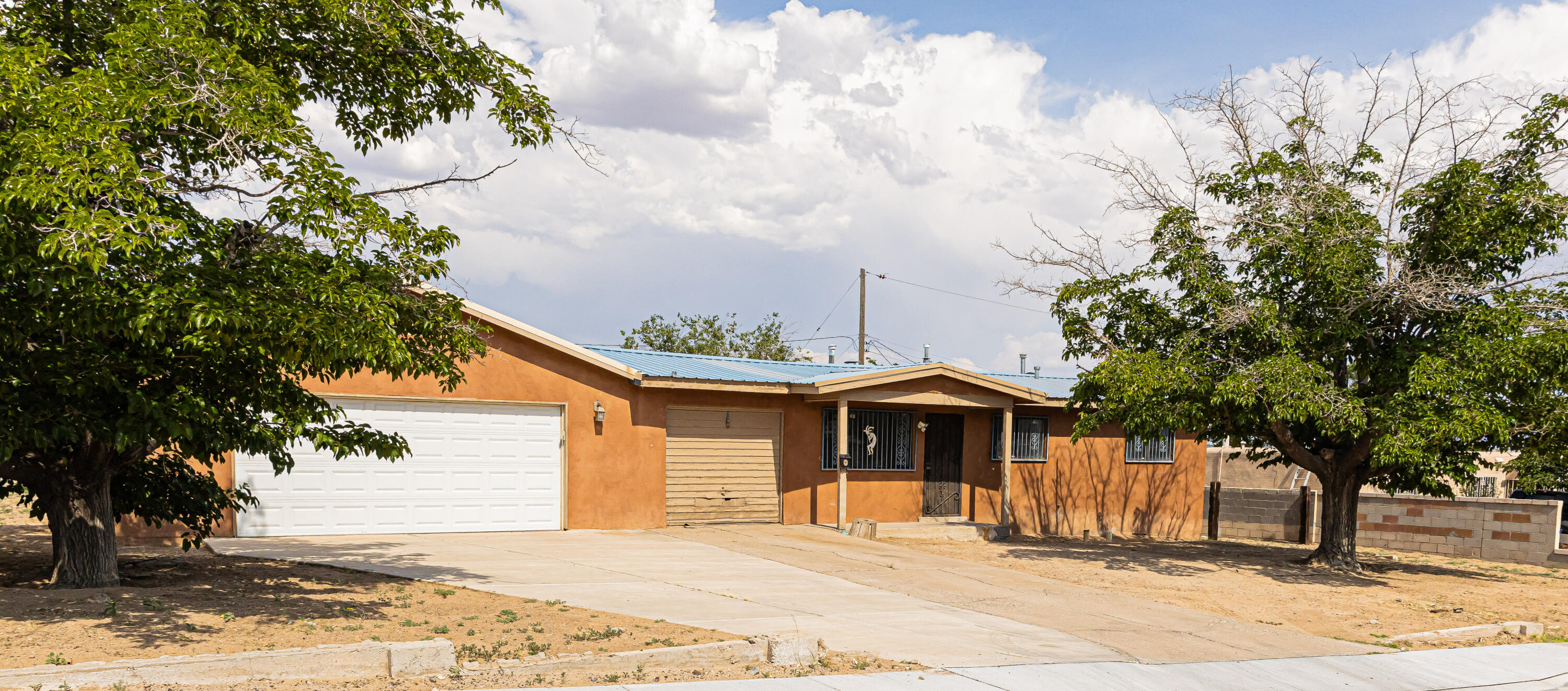 Wonderful 3 Bed/1 Bath home located in the SW of Albuquerque. Home has a 4 car finished garage with an additional bathroom. The home has an additional 1 car garage for storage or extra space to add on to the home. Total of 5 GARAGES or 1,150 extra sq footage as a bonus for the home. Ideal for all your cars and toys. Home sits on almost 1/4 acre corner lot. Side yard on both sides of the home and garage has outdoor access to the backyard. Fresh paint throughout the home. Refrigerated Air. Metal Roof.  New carpet in the bedrooms. Make an appointment today!