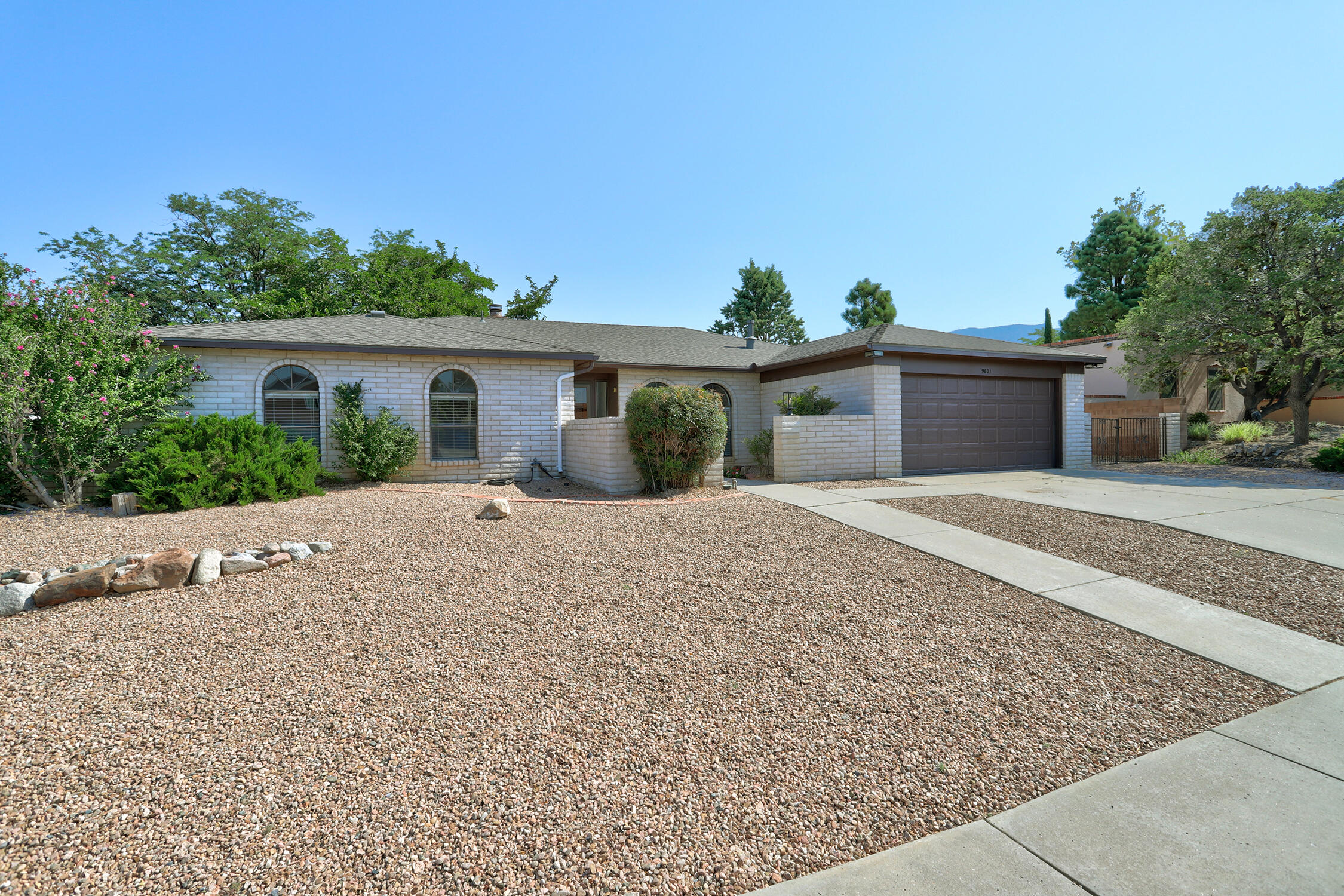 Welcome to your dream home! This stunning 4-bedroom, 2-bathroom residence has been beautifully remodeled. Inside this home, you will find new flooring, fresh paint, new lighting fixtures, and a gorgeous kitchen remodel, including new quartz countertops, a farmhouse sink, a new refrigerator, and dishwasher. The bathrooms are also updated, and to top it all off, a brand-new roof. Filled with natural light, this home features a cozy fireplace and a large backyard with breathtaking views of the Sandia Mountains. Nestled in one of the most sought-after neighborhoods, with some of the best public and private schools nearby, this home offers a perfect blend of modern amenities and timeless charm, All you need to do is move in. You won't want to miss this one!