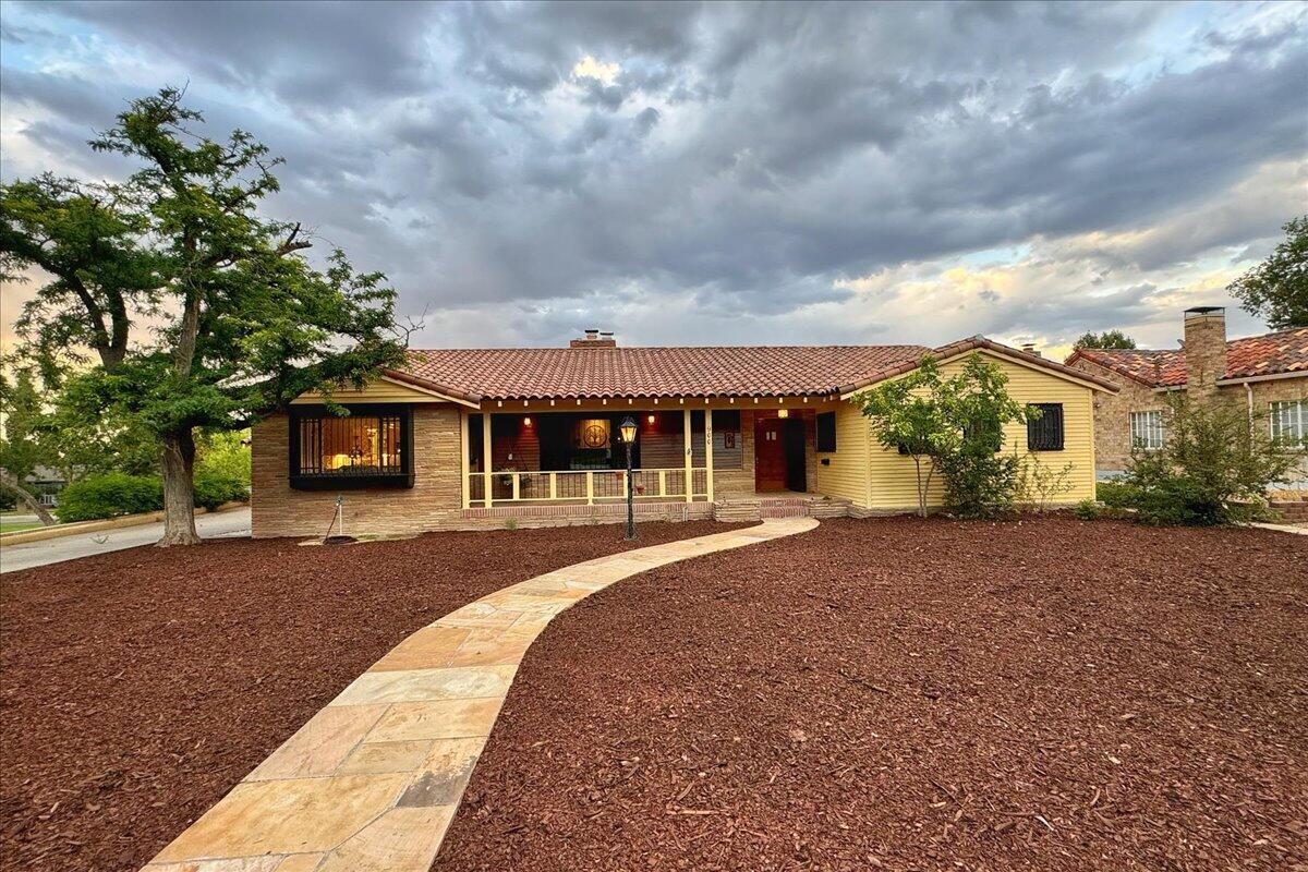 Nestled in a picturesque setting next to a beautiful park with breathtaking mountain views, this custom-built ranch-style house exudes timeless charm and elegance. Constructed with rich wood beams, vigas, latillas, and hand-scribed plaster walls. The interior is adorned with built-in original artwork and custom woodwork showing the craftsmanship and attention to detail put in throughout the home. Cove ceilings and oak flooring enhance the warmth and sophistication of the living spaces and four inviting fireplaces ensures cozy comfort in every season. Additionally, owned solar panels provide energy efficiency and sustainability, making this stunning residence a perfect blend of traditional beauty and modern amenities. 3650 main level and 1636 heated basement