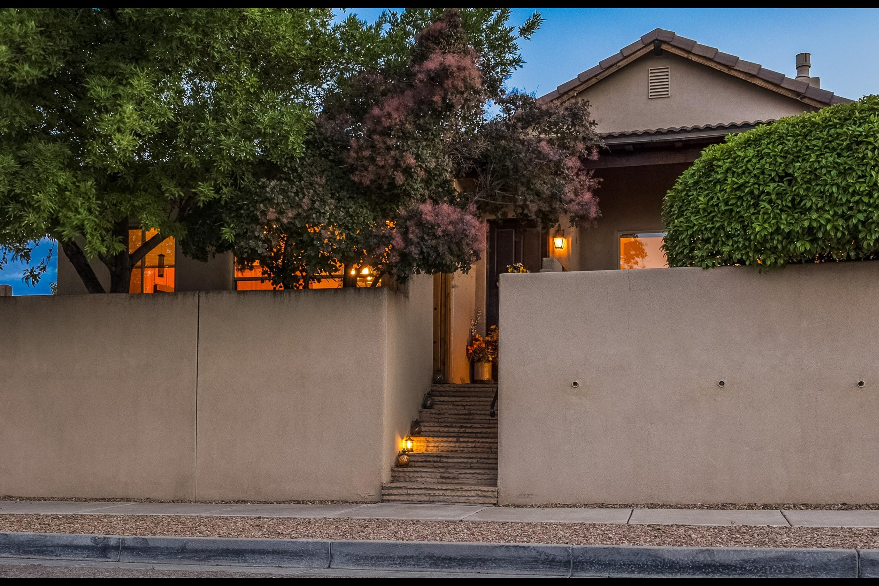 Discover tranquil & energy-efficient living in Andalucia with this stunning patio home featuring OWNED SOLAR PANELS with electric bills in the single digits! Enjoy breathtaking views of the valley, mountains, and city lights from this well-designed 2,037 SF residence, which includes 3 bedrooms and 3 bathrooms. High ceilings, skylights, and a dual-sided fireplace enhance the open-concept floor plan. The kitchen boasts granite countertops and newer appliances, including an induction oven. The master suite offers a private patio, walk-in shower, dual sinks, a garden tub, and a spacious closet. This home also features a newer roof. Embrace New Mexico outdoor living with 3 private patios, xeriscaped with new irrigation and fruit trees. Conveniently close to trails, parks, and shopping.