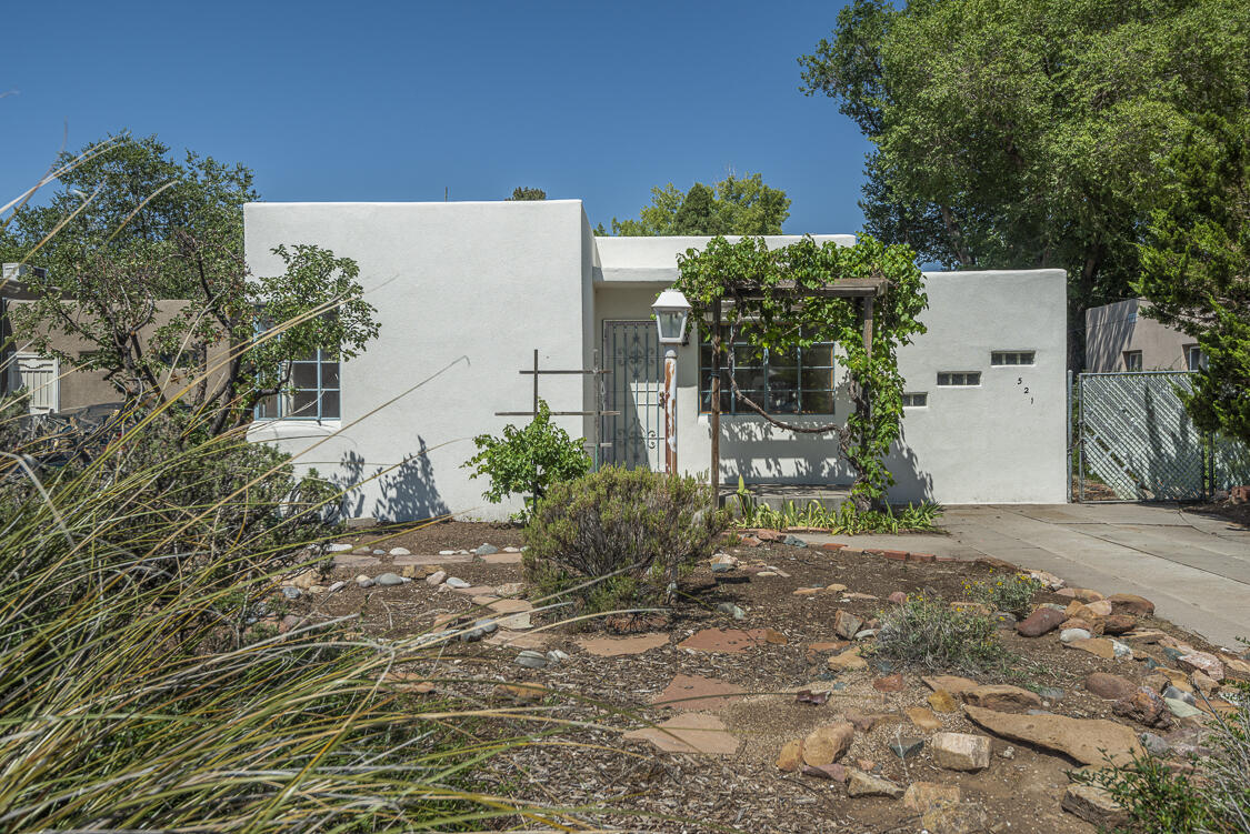 This charming 3 bedroom, 1 bath house located in the heart of residential Nob Hill offers a delightful blend of historic features and modern updates. The home exhibits characteristics of the historic architecture of Pueblo Revival and International Style with an ''eyebrow'' over the front door. Stepping inside, you are greeted by a decorative corner fireplace, coved ceilings and arches throughout adding a touch of elegance to the home. The interior boasts beautiful hardwood floors that exude warmth and character. The house features a charming kitchen, where you can prepare delicious meals while enjoying the vintage charm of the space. The care and attention to detail put into maintaining this home are evident in every corner, making it a truly special place to call your own.