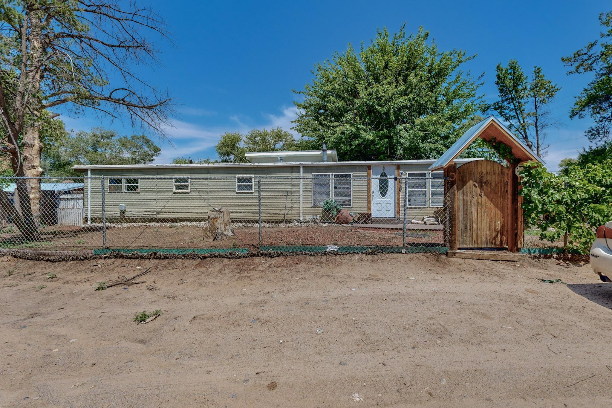 A welcoming home nestled in the beautiful seclusion of the South Valley. It is a manufactured home sitting on a .5 of Agricultural land right next to a ditch. It has back yard access with a storage and a carport. You will love the soothing outdoor space to grow your garden or simply to enjoy a great barbeque with family and friends. Call your realtor for a showing today!A must see to appreciate it the home.