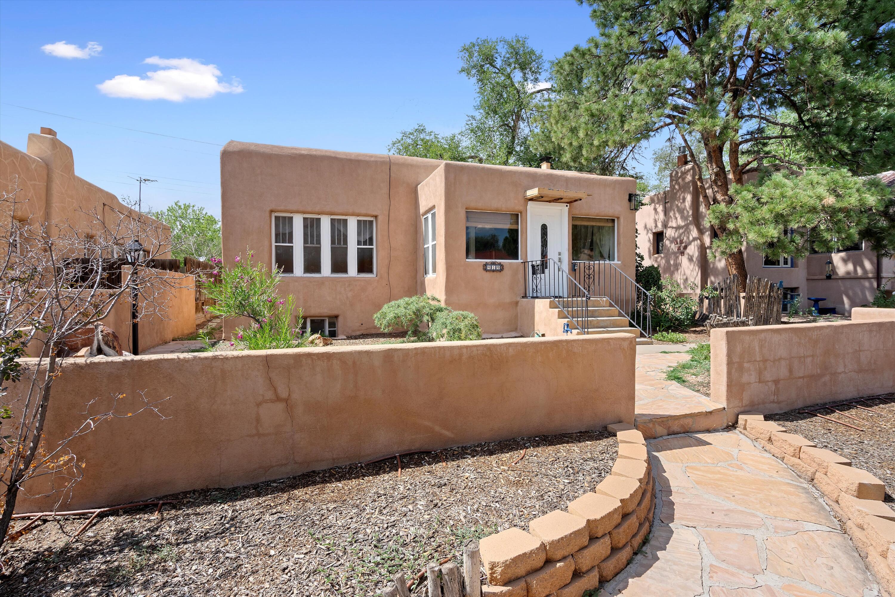 Welcome to this charming adobe home in Spruce Park. This vintage home from the 1920's is full of character and style. Beautiful foyer with loads of natural light, opens to a large family room with fireplace and a spacious dining area as well. Complete kitchen renovation just completed with Allen Roth cabinetry, quartz counters, tile backsplash & new stainless steel appliances.  On the main level you'll find the primary suite with numerous windows and a kiva fireplace. Downstairs you'll find multiple bedrooms, a bathroom and a large laundry room. Walkout basement provides for numerous options depending on your specific needs. Relax on the private back patio with brick pavers.  Entire home has been re-plumbed with PEX.  Come see it today.