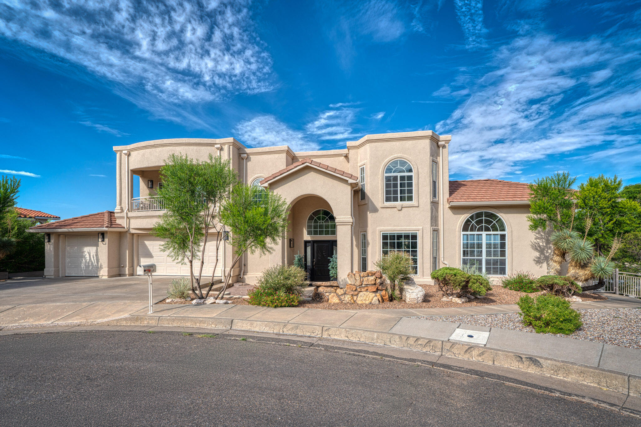 Exceptional home with luxurious amenities, nestled in the foothills with panoramic views of the Sandias and minutes away from walking and biking trails. Completely renovated with 100% high end appliances and finishes, all new and waiting for its new owner. Remodel includes new roof, stucco, a/c units. A Chef's dream gourmet kitchen with new high end WOLF appliances, 5 burner gas cooktop with pot filler and Vent a Hood, THERMADOR Refrigerator and KRAUSS stainless steel country sink with filtered water, new Thomasville cabinets with granite waterfall countertops. Living room & kitchen open to the outdoor privacy deck, bringing the outdoors in. For pet owners, there is a terraced and gated dog run.  Stunning views from every window. Spacious and oversized 3 car garage with 4x4 storage room.