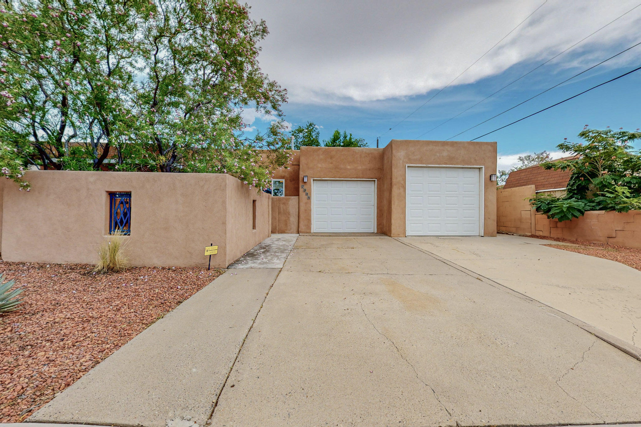 This charming home is capaciously designed for comfort and aesthetic appeal. As you step inside, you're greeted by a spacious dining and kitchen area bathed in natural light, thanks to large skylights above and throughout the home. The master features ample space, a large closet, and a full bath, with access to the back patio. All bedrooms feature hardwood floors that add warmth and character. The rest of the home is adorned with sleek, easy-to-maintain tile flooring. The living area boasts a fresh light with the coziness of the fireplace and a carefully placed wet bar for easy hosting! Two of the bedrooms include a Jack and Jill bathroom, with one of the bedrooms featuring back patio access.