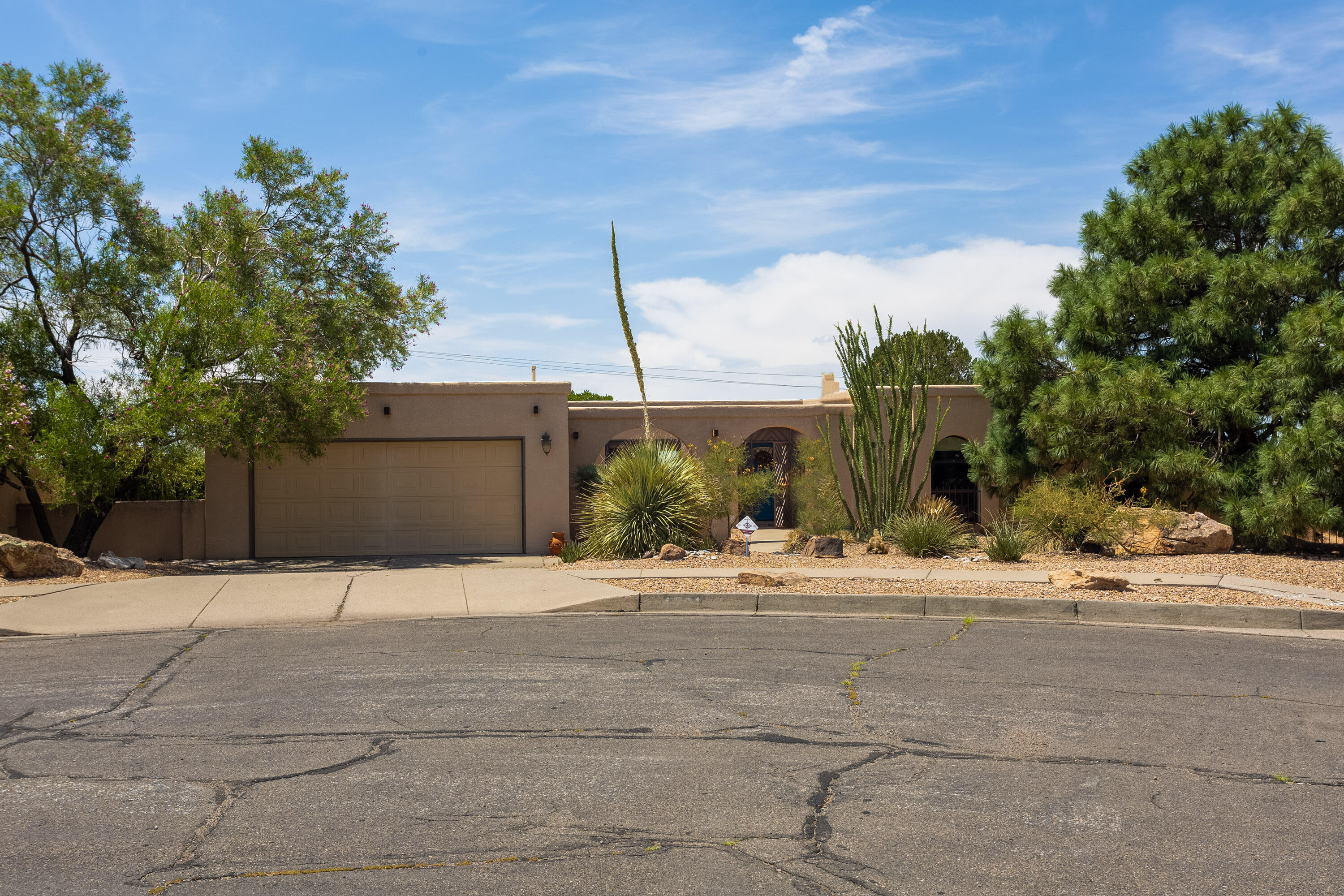 Holy Smokes! This charming (old world meets new world) and incredibly well maintained foothills home boasts GORGEOUS  wood ceilings, beautiful hardwood flooring in living areas, and a sweeping and tiered backyard with actively producing fruit trees and a basketball court. The .43 acre lot offers so much in this coveted foothills neighborhood! TWO Kiva fireplaces (one in the primary suite) are perfect for cozy foothills evenings. The home features a combo refrigerated Air/Heating unit, newer kitchen appliances,, two living areas, and an open and elegant, yet functional floor plan. Come see this truly charming home and make it yours!