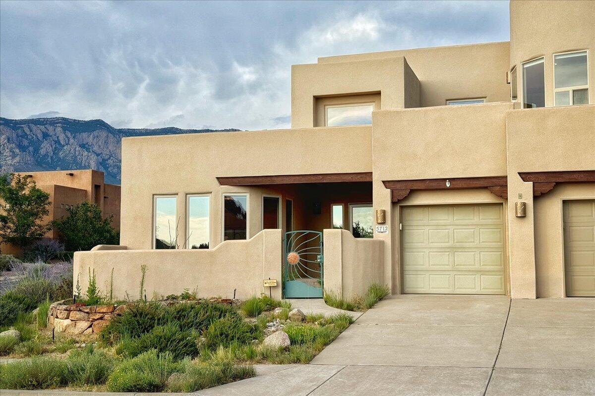 Beautiful one owner home in the Solterra subdivision of High Desert with stunning mountain and city light views. The grand entry with double-height ceilings leads you into a light-filled living space featuring a 20-foot-tall wall of windows and a floor to ceiling kiva fireplace. Showcased are the custom architectural glass windows by renowned artist Salvadore M. Equihua. The open kitchen, dining and living areas are the perfect entertainment space, providing direct access to the private back patio complete with a koi pond and waterfall.  The home's expansive design is immediately evident with spaciousness felt through all rooms and corridors.  The private upstairs primary bedroom includes a huge bathroom featuring a jetted walk-in shower, large soaking tub, dual vanities, and an oversized