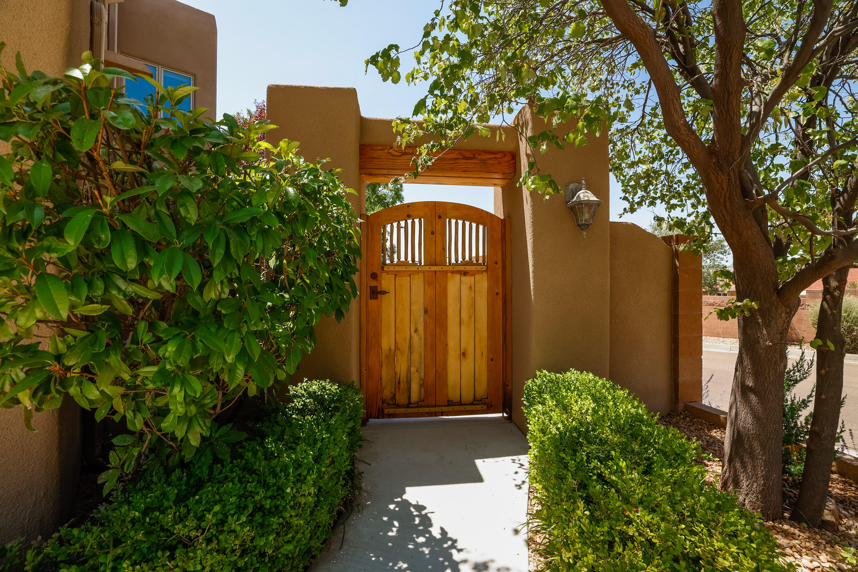 A beautiful unique and spacious two-story townhome end unit with views, views, views. Enter through a gated and private courtyard to access the entry and the exterior yard with mature trees and bubblers and a timer for easy landscaping. The main floor offers an entertainment living room, 2 large bedrooms with walk-in closets, 3/4 bath with 2 vanities, a gas two-sided fireplace and 2 covered patios with beams, vigas and T&G ceilings. The oasis on the second floor is an entertainers dream with an open concept, tons of windows with gorgeous city and mountain views. This spacious floorplan offers the kitchen, dining area, great room, primary bedroom and full bath, laundry, a guest half bath and 2 covered decks.  The primary bath includes double vanities, a doorless shower and a claw iron tub.