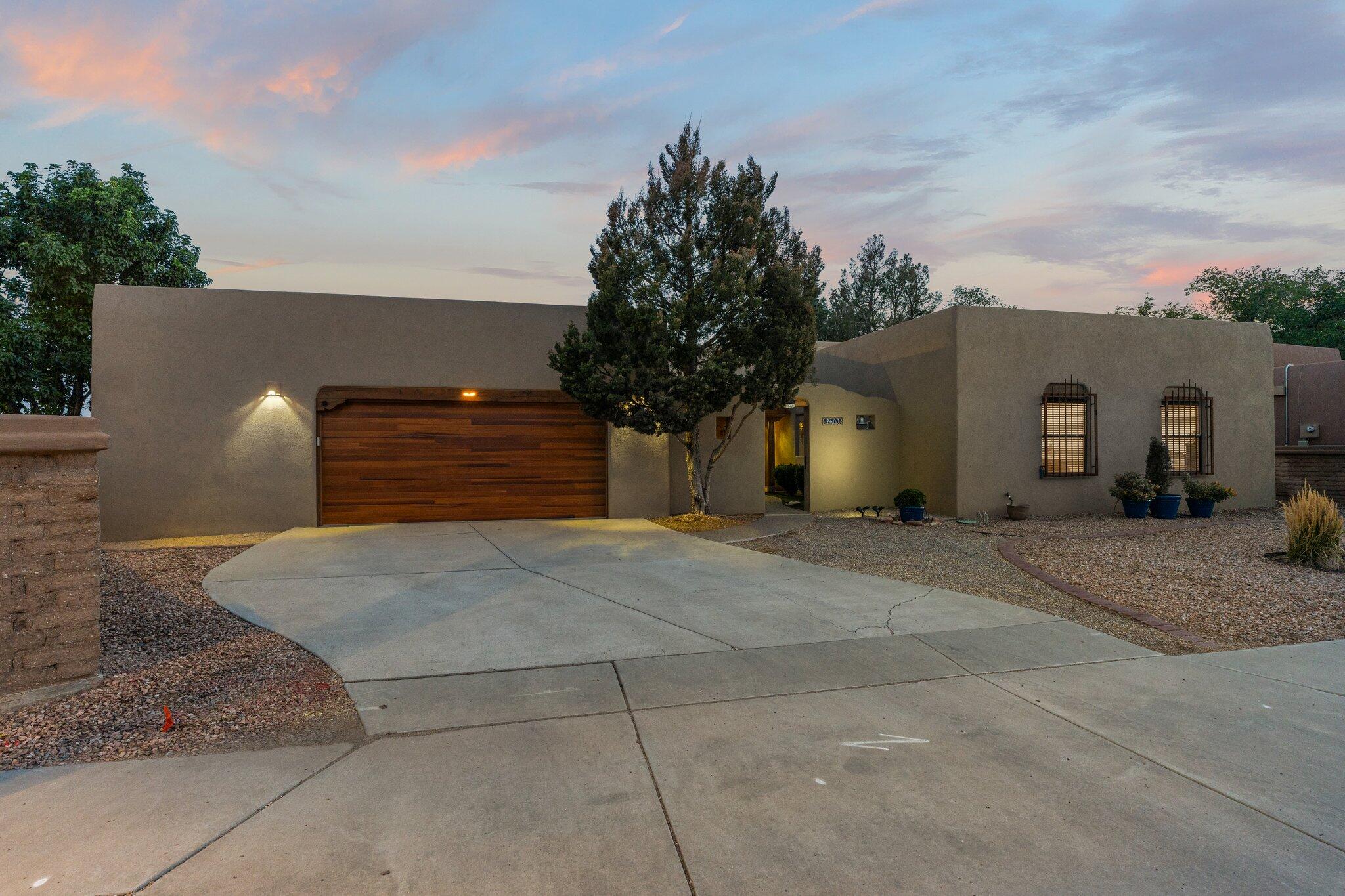 This impeccable single level Southwest-style home on a .25-acre corner lot in the prestigious North Valley offers a blend of charm and modern updates. Featuring two living areas, a gated courtyard entry, and a garage with a workshop. The stunning family room boasts exposed adobe walls, 10ft tongue & groove ceilings, brick flooring, and a custom kiva fireplace. The updated kitchen includes granite countertops, stainless steel appliances, and a large bar area. The master suite features outdoor access and a spa-like shower. The fully landscaped yard has a covered patio. $200,000+ in upgrades including TPO roof, stucco, HVAC system, water heater, custom handcrafted doors, some flooring, skylights, garage door and more. located near Old Town, Bio Park, and the Sawmill District. Move-in ready