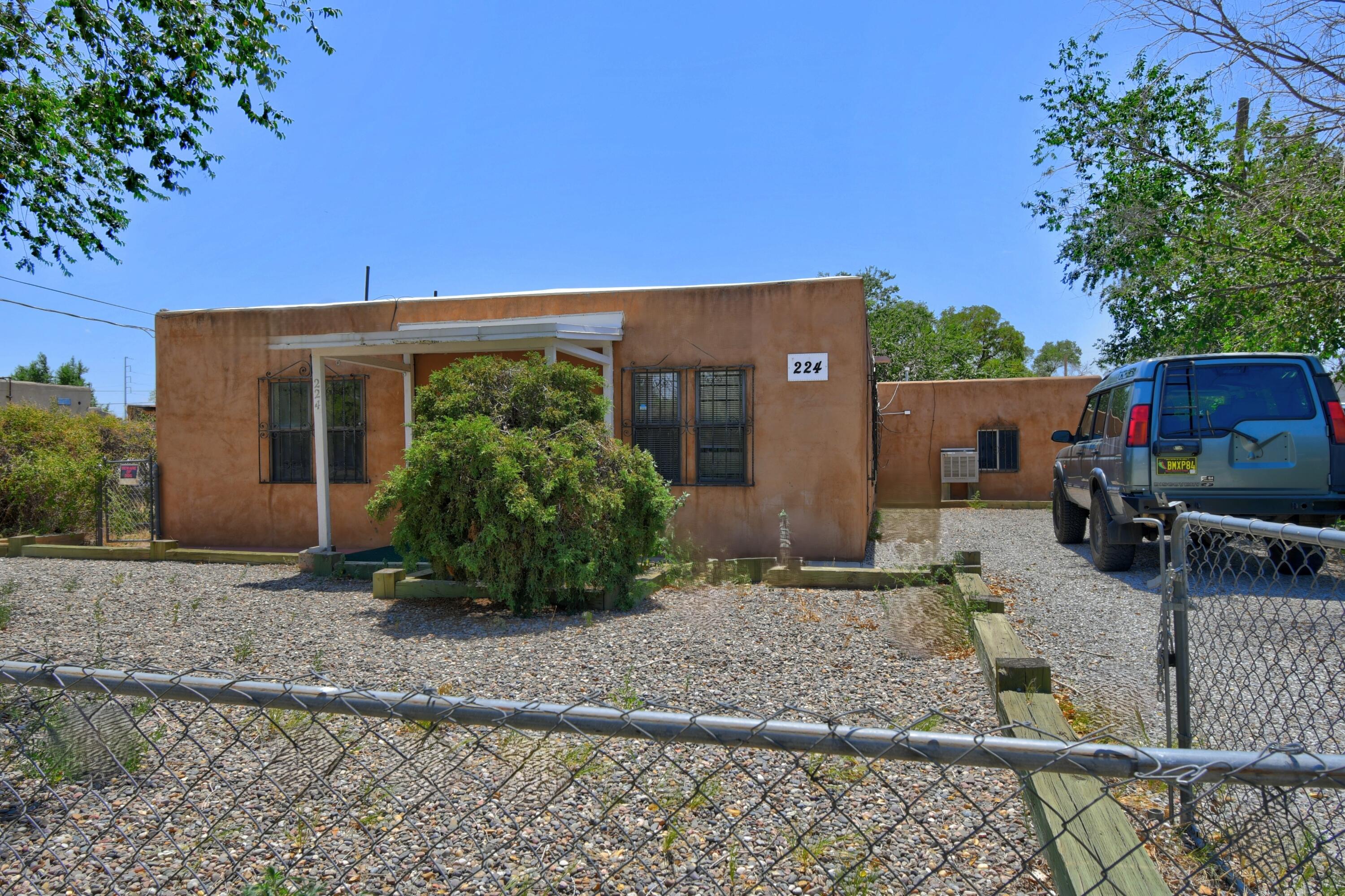 Great Opportunity. Adobe 4-bedroom home. Wood flooring beneath just waiting to be brought back to life. Possible In-law Suite or separate Apartment rental!  Great location. Generous sized rooms. OR if you are looking for a rare opportunity to own a standalone multi-use building in the north valley. Security Iron windows for your comfort. A ready to occupy investment property with multiple rooms that can support multiple business offices with private and separate entrances.  Possible uses, office. services equipment services, headquarter, outpatient psychiatric clinic, and medical spa. Convenient location off Montano. Surrounding area developments. New TPO Roof with warranty.  Property being ''SOLD AS IS''