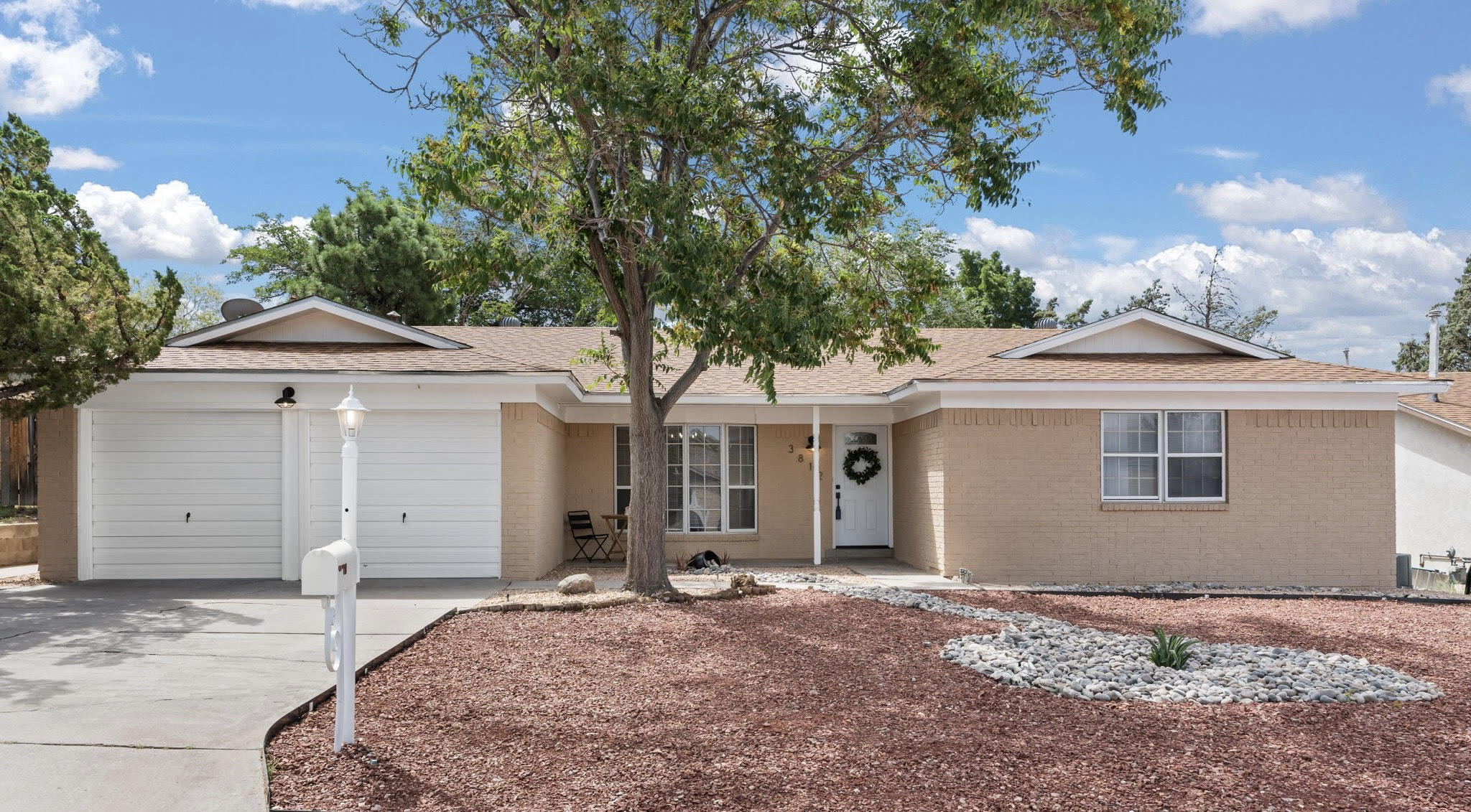 Welcome to your potential new home in the heart of Albuquerque! This house is a breath of fresh air, combining modern elegance with comfort. As you step inside, you'll be greeted by an abundance of natural light streaming through the windows, creating a warm and inviting atmosphere.The spacious interior boasts 1,917 square feet of living space, including four bedrooms and two bathrooms, perfect for families or those who love to entertain. The open kitchen is a chef's dream, featuring sleek appliances and ample quartz counter space. The living room is a cozy retreat, complete with a wood-burning fireplace. The dining room features oversized built-in bookshelves, ideal for showcasing your literary collection or displaying cherished