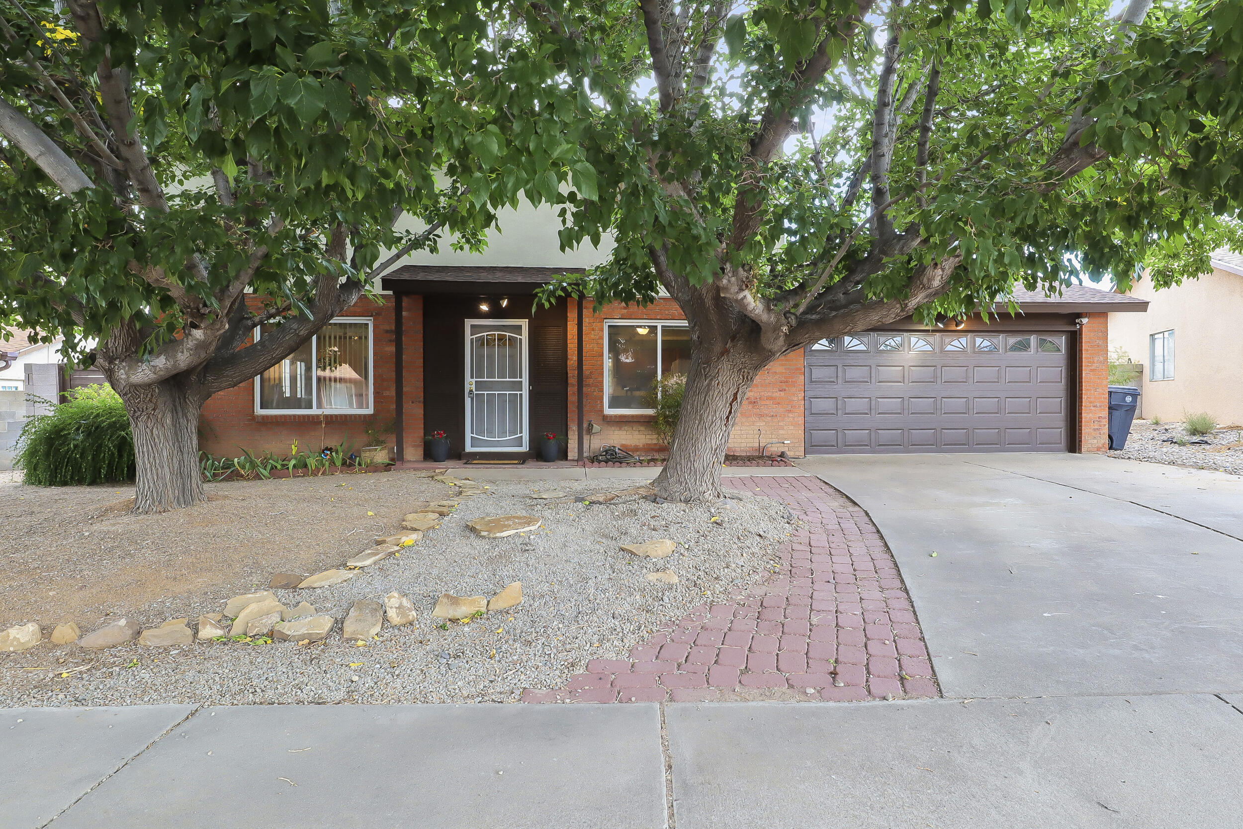 Discover one of the neighborhood's true gems! This beautifully upgraded home features refrigerated AC and stunning shade trees that enhance the front yard, making it the best in the area. The oversized backyard is perfect for entertaining, complete with a custom patio, hot tub, mountain views, and space for your outdoor furniture. Inside, enjoy a generous primary suite with new carpet, a remodeled bathroom, and a walk-in closet. The cozy downstairs living area, featuring a fireplace, connects to a lovely kitchen and new patio doors leading to a greenhouse. Don't miss out--schedule a viewing today!