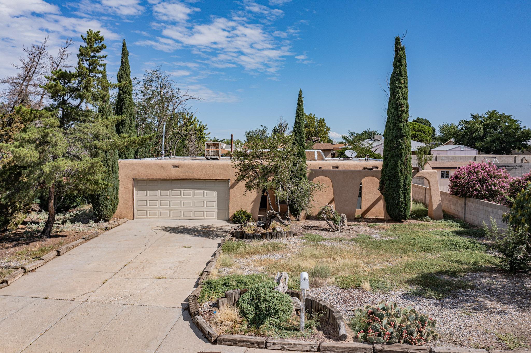 Terrific location directly across the street from Sister Cities Park, overlooking beautiful green space complemented by surrounding mountain views. Unique curb appeal featuring an arched front walkway & mature columnar trees framing the property. Open concept layout with fresh paint & brand new flooring throughout, making for a crisp & clean interior. Central wood-burning fireplace in the main living area with space for a formal dining room, leading to the kitchen boasting scenic backyard views. Kitchen updates include new countertops, oven, vent-a-hood & freshly painted cabinets with new pulls added. Sizable & private backyard with patio space & great opportunity for more landscaping. Large 2-car garage. Easy access to I-25, minutes to Sprouts, Whole Foods, Arroyo Del Oso +much more!