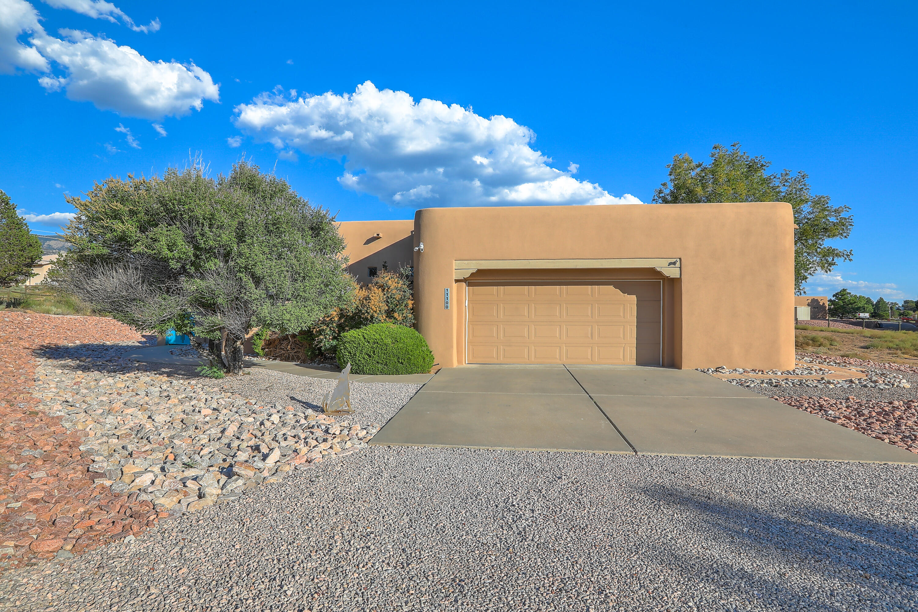 WELCOME HOME to this stunning single-story home with gorgeous tongue-and-groove ceilings, 2 kiva fireplaces, refrigerated air, and an oversized 2.5-car garage. Located on a beautiful .89-acre property in North Albuquerque Acres, an additional structure or pool could be added to enhance outdoor enjoyment. Custom design and finishes include a lovely floor plan,  Pella windows, pine doors, radiant heat, and forced air. The spacious gourmet kitchen has newer appliances, sinks, and quartz countertops! A large owner's suite with a generous, updated bath is separated from other bedrooms for privacy. The kiva fireplace,  large walk-in closets, and mountain views make this a beautiful retreat. Enjoy the east and west side covered portals for mountain views and sunsets!