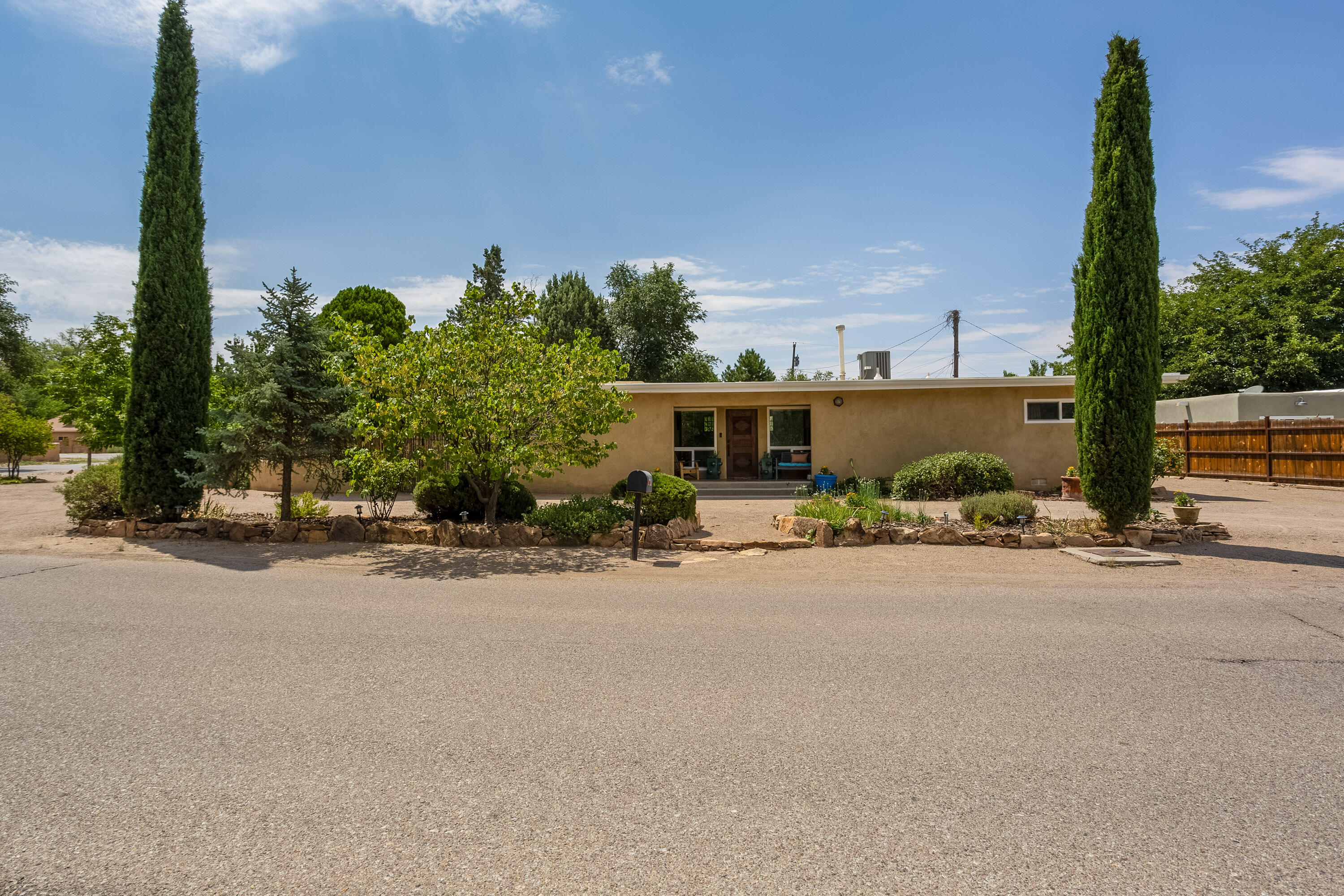 Adorable home in Los Ranchos with a casita! This homes features 3 spacious bedrooms, 2 bathrooms, open kitchen with stainless steel appliances, gas stove top and concrete counter tops! Wood floors, wood burning fireplace and plenty of natural light. Beautifully landscaped front and backyard. AC and newer roof in main home and casita! Casita is perfect for in law quarters, home office or rental income.