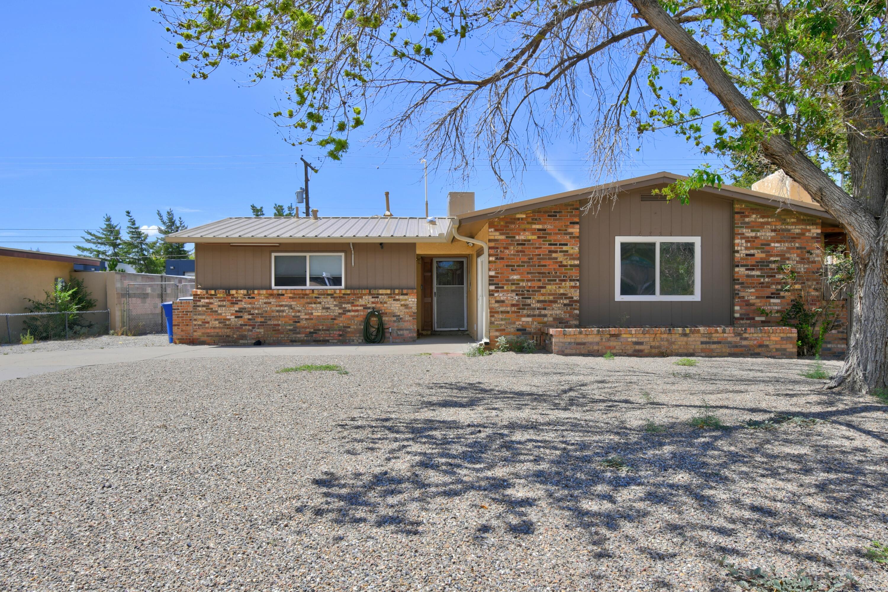 Charming single story home in a highly desirable part of the NE heights! Bright & open floor plan with fresh paint, tankless water heater, newer carpet & new metal roof in early 2024! Kitchen with stainless steel appliances and additional cabinetry overlook the dining area. Oversized den with fireplace! Huge lot with covered patio, storage shed and backyard access! Easy freeway access, close to shopping/restaurants and just down the road from Arroyo Del Oso golf course!