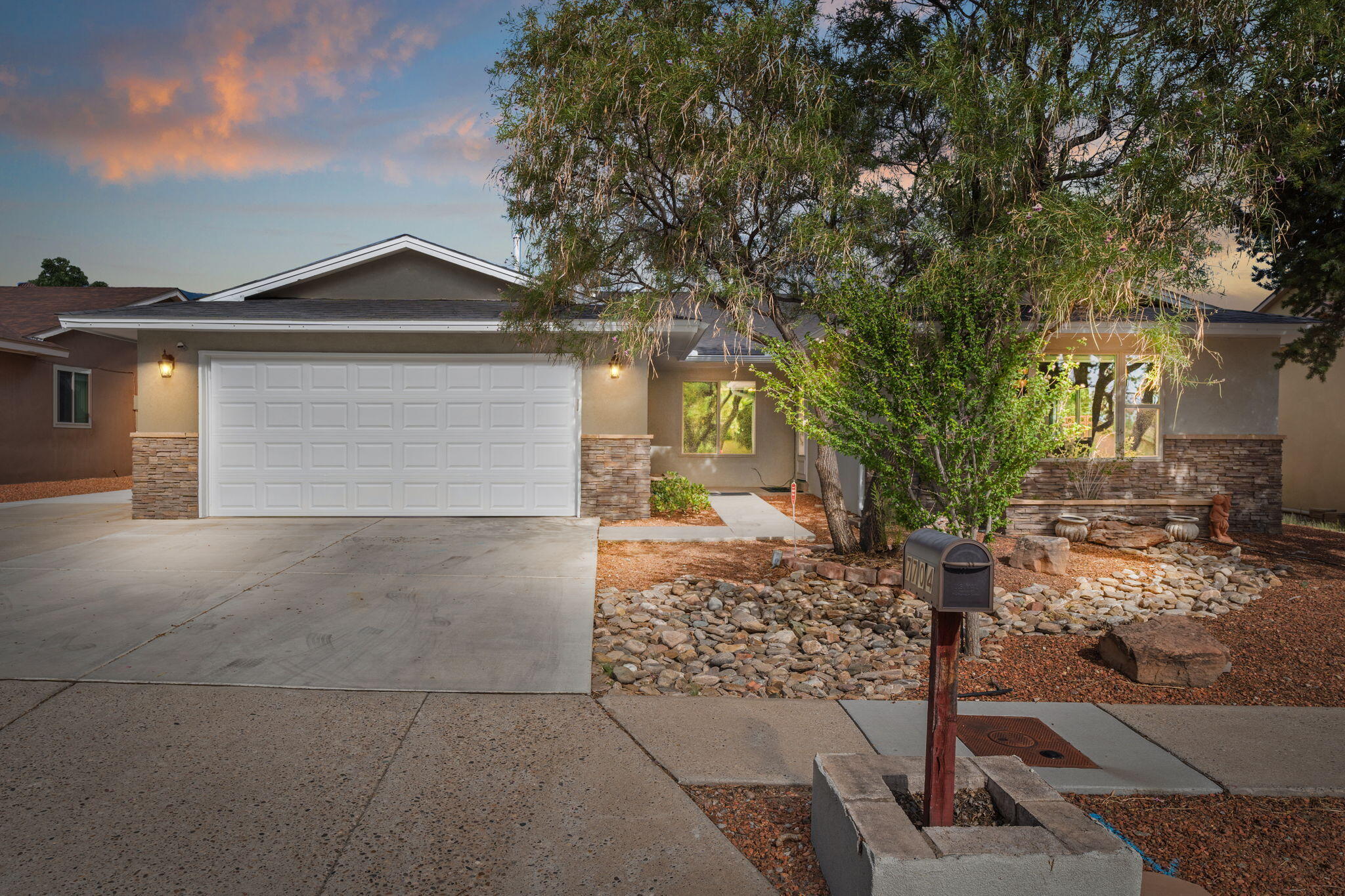 Enjoy stunning Sandia Mountain views from this beautiful home in the sought-after La Cueva school district. With its attractive curb appeal & convenient 2-car garage, it makes a strong first impression. Inside, enjoy a mix of carpet, tile, & laminate flooring. The kitchen features dark cabinetry, a sleek island, granite countertops, tile backsplash, & modern lighting. Skylights brighten the spacious living area, while the master suite offers a walk-in closet and an ensuite with a separate shower, garden tub, & dual vanities. Additional highlights include backyard access, a dedicated laundry room, refrigerated air, and mini-splits for year-round comfort.The landscaped front and back yards add appeal, & the private, walled backyard with a covered patio is perfect for relaxing. Welcome home!