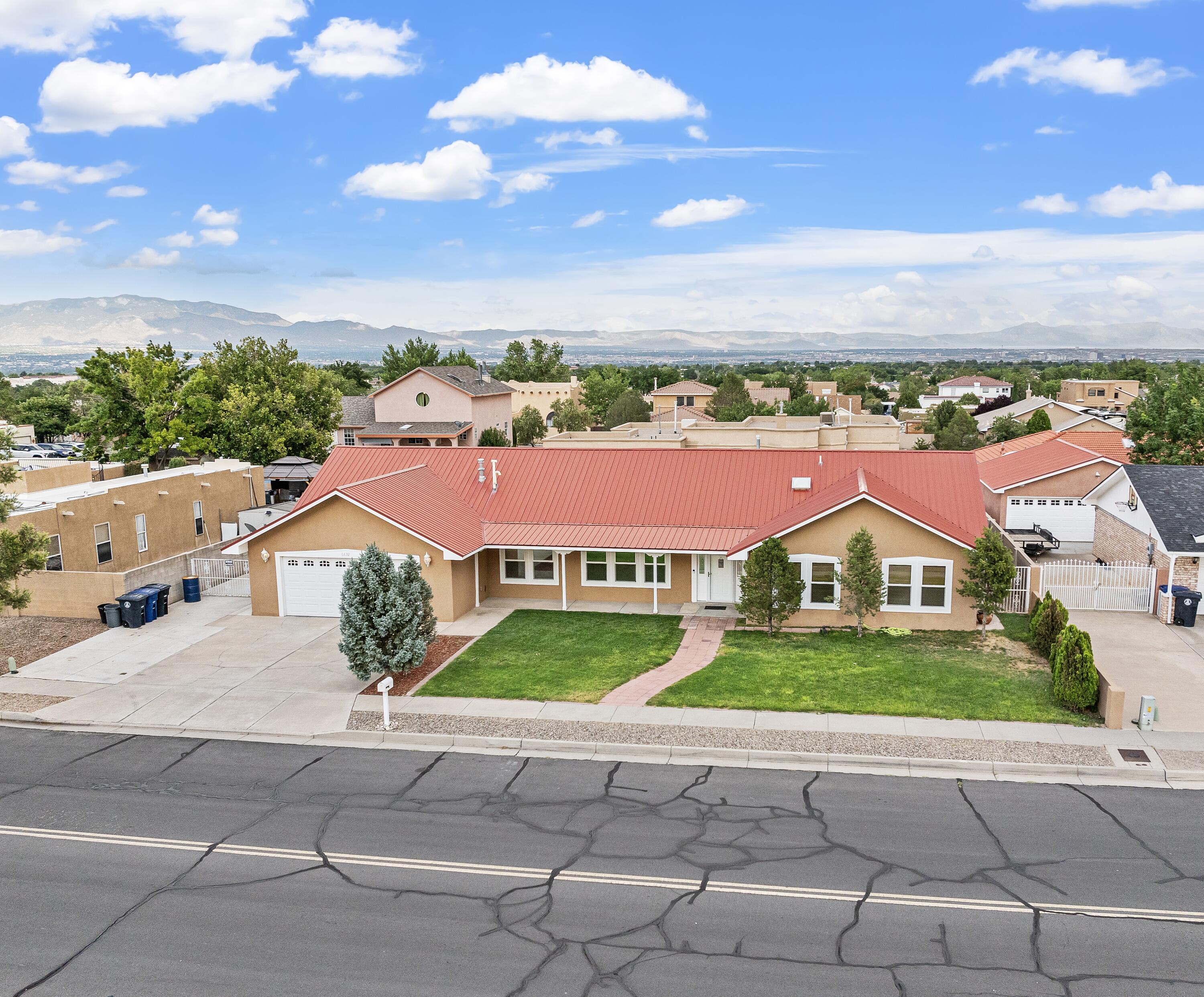 Discover this exquisite Albuquerque home, perfect for families or those desiring extra space. With 4 bedrooms and 2 bathrooms, it offers ample room and comfort. The interior features luxurious granite countertops, elegant wood plank floors, and fresh carpet. The grand living room, with its high-pitched ceilings, creates an airy, open feel. Enjoy year-round relaxation in the massive underground, heated pool, complete with an electric cover. The energy-efficient solar panel system powers the home, while Ethernet wiring ensures seamless connectivity. A newer metal roof enhances the home's durability and appeal. The backyard is a true haven, meticulously designed with a spacious patio, lush landscaping, and a built-in pool, perfect for entertaining or unwinding under the stars.