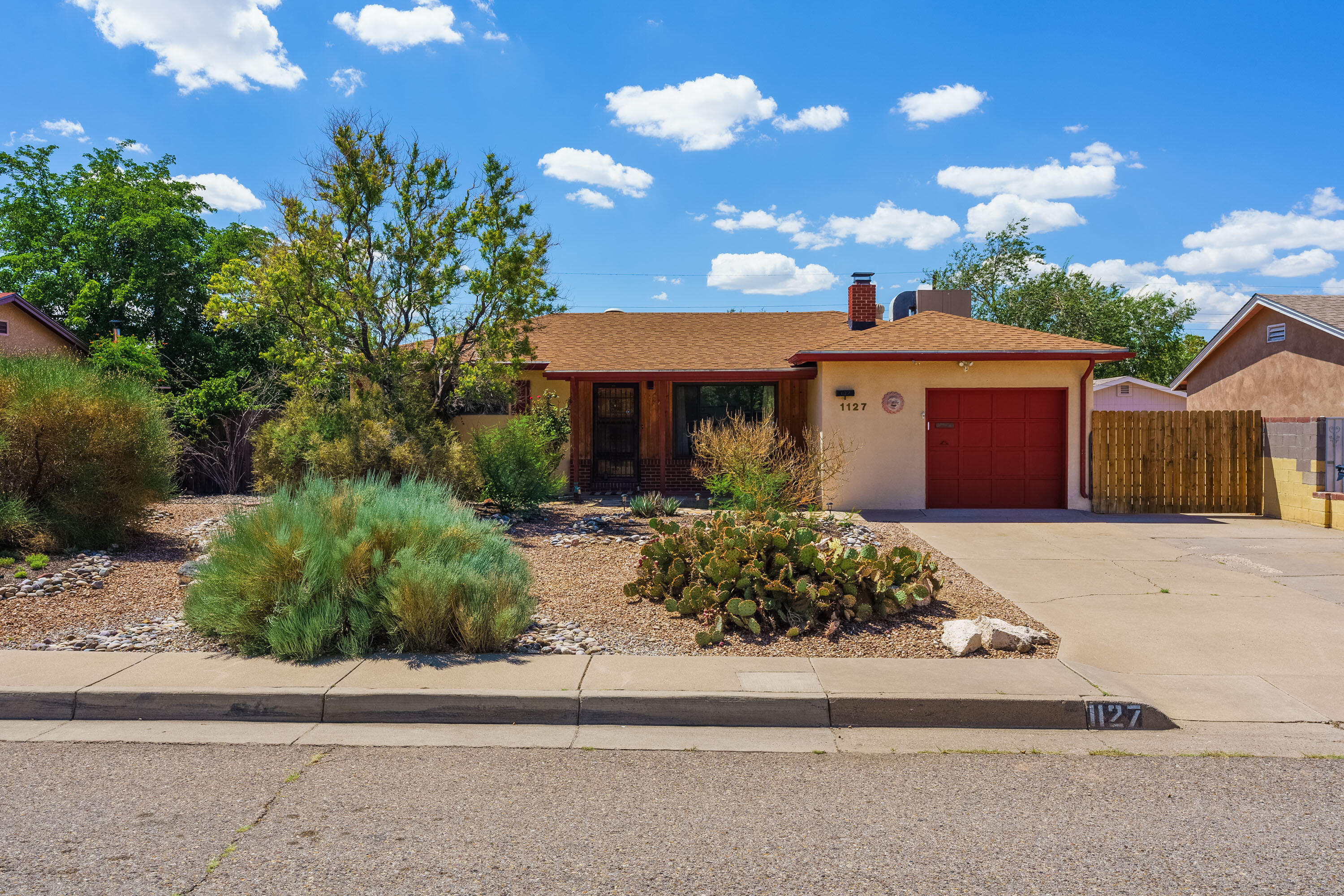 This Northeast heights home features gleaming wood floors, 3 bedrooms, two spacious and open living areas, two cozy fireplaces, a bonus room/sunroom, and a backyard with plenty of space and storage! Very easy access to I-40, this home is conveniently located to shopping and restaurants and is just a short drive to Kirtland AFB and downtown ABQ. Enjoy this home's sideyard access- perfect for small recreational vehicles or an extra car. This bright and cheery, well maintained home is ready for you! All appliances convey. Square Footage in process of being verified.