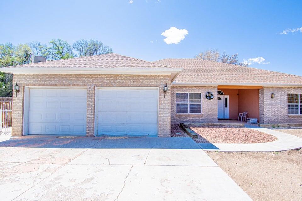 Tucked away on a quiet road in the agricultural neighborhood of the South Valley is a 2836 sq ft home with a 430 sq ft detached casita on nearly .5 acre lot. Main home hosts 3 bed 3 bath + office. Formal dining room, built in appliances in the kitchen, convection oven and cooktop stove in the Island. Sunken living room has a gas log fireplace and wet bar with fridge. Walk upstairs from the primary and enjoy the balcony views. Primary bath offers a jetted tub and a 2 headed shower with a walk in closet. Radiant heat ,mini splits and evaporative cooling in the main home. The detached casita is a heated 1 Bed 1 Bath with laminate wood floors. Fully fenced with brick and wrought iron fencing in the front of the home and a spacious backyard with a shed and views. Private well and city sewer.