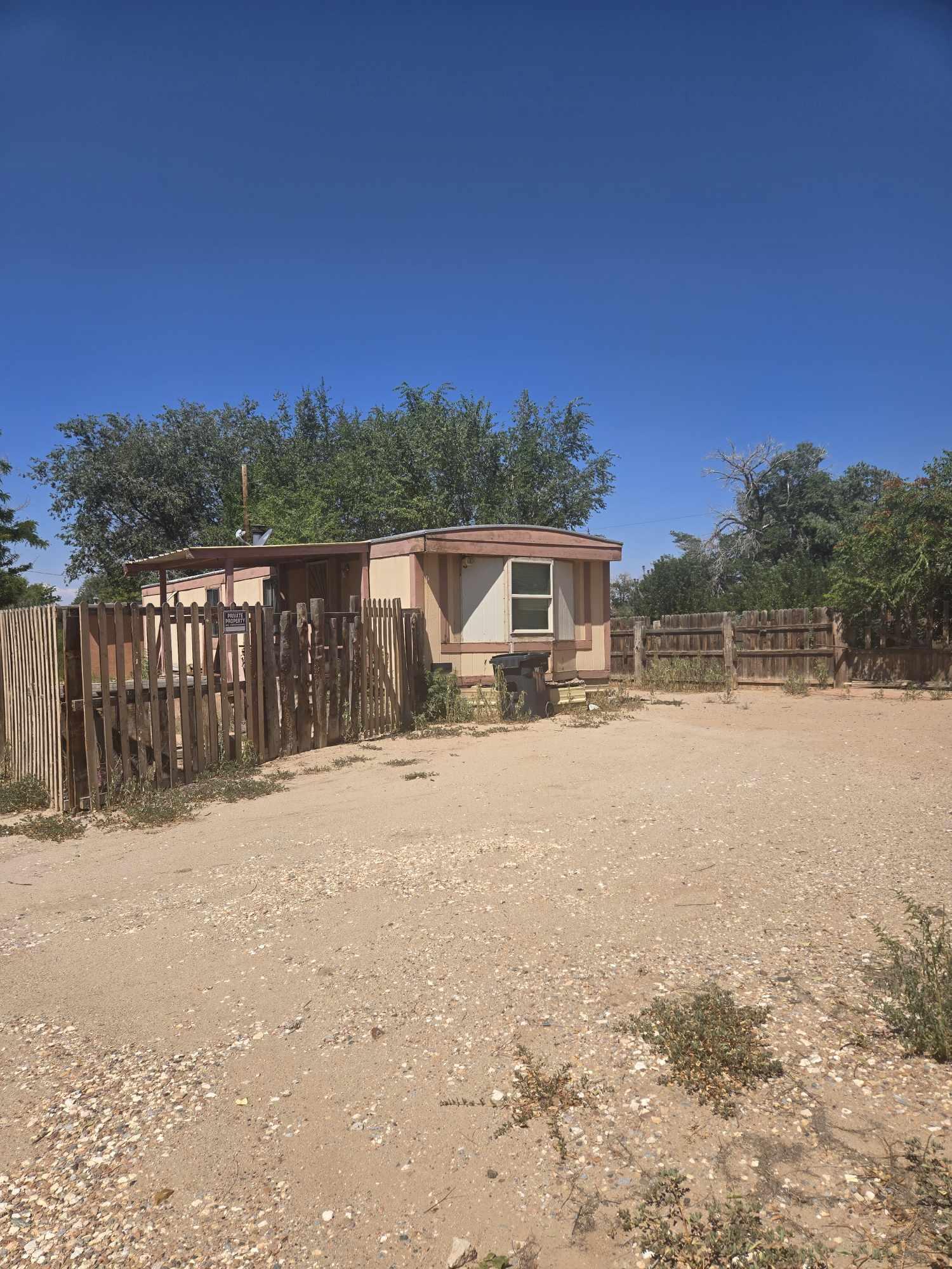 GREAT POTENTIAL! Calling all Investors!!! Great opportunity in the hear tof the North Valley. 1 bed/1 bath manufactured home on almost .25 acres. Detached one car garage with large work shop. Additional detached unit has access to plumbing and electrical. Owner Finance available with 20% down, 7.5% interest, 5-year call.