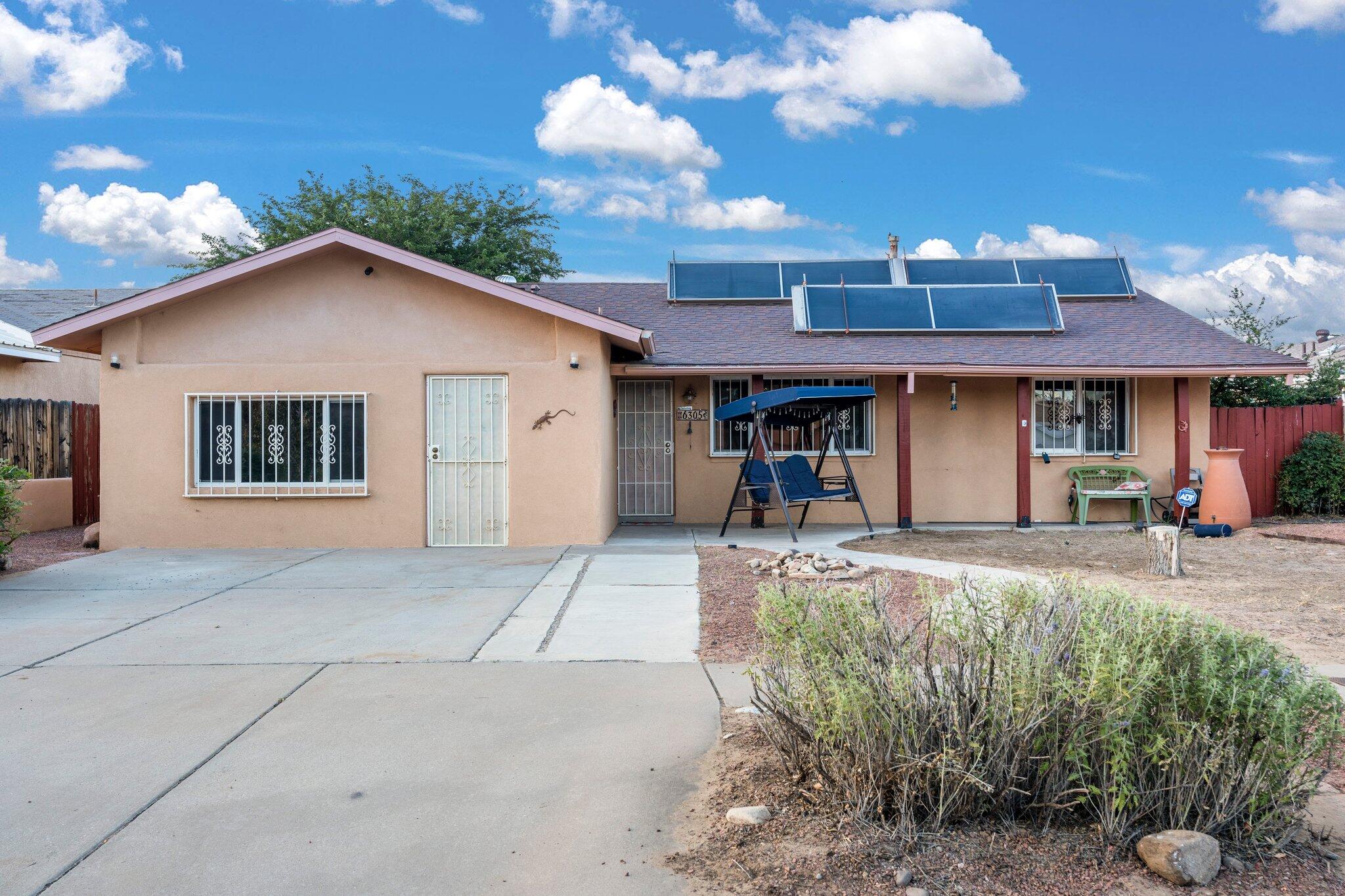 Welcome to a stunning well-maintained home nestled on a 0.19 acre lot. This beautiful property offers modern comfort with 3 spacious bedrooms, 2.5 baths, and an open floor plan perfect for entertaining. Update includes Tankless water heater, new tile flooring, and hot tub. Great room features a big picture window to let the NM Sunshine in! The kitchen boasts marble countertops, oak cabinets, breakfast bar & open to the Great room. The cozy living room includes a wood stove fireplace. This home was the original model for the builder and it was built with a fabulous large home office in lieu of garage! Step outside to a private backyard with breathtaking mountain views. Conveniently located near schools, shopping, and parks, this home is move-in ready!