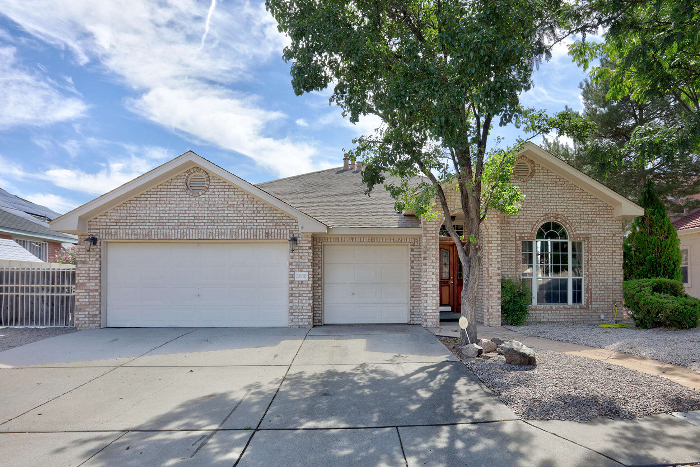 Welcome to this stunning, meticulously maintained single-story home, offering 2,302 square feet of elegant living space. Nestled in a serene neighborhood, this residence features four spacious bedrooms and three full baths, perfectly blending comfort and luxury. The open floor plan invites you to enjoy seamless transitions between the living, dining, and kitchen areas, creating a warm and welcoming atmosphere ideal for both relaxing and entertaining. Expansive windows throughout the home frame breathtaking views of the lush golf course and the majestic Sandia Mountains, providing a picturesque backdrop to daily life. Step outside to your private patio, where you can bask in the beauty of your surroundings while taking in spectacular views.