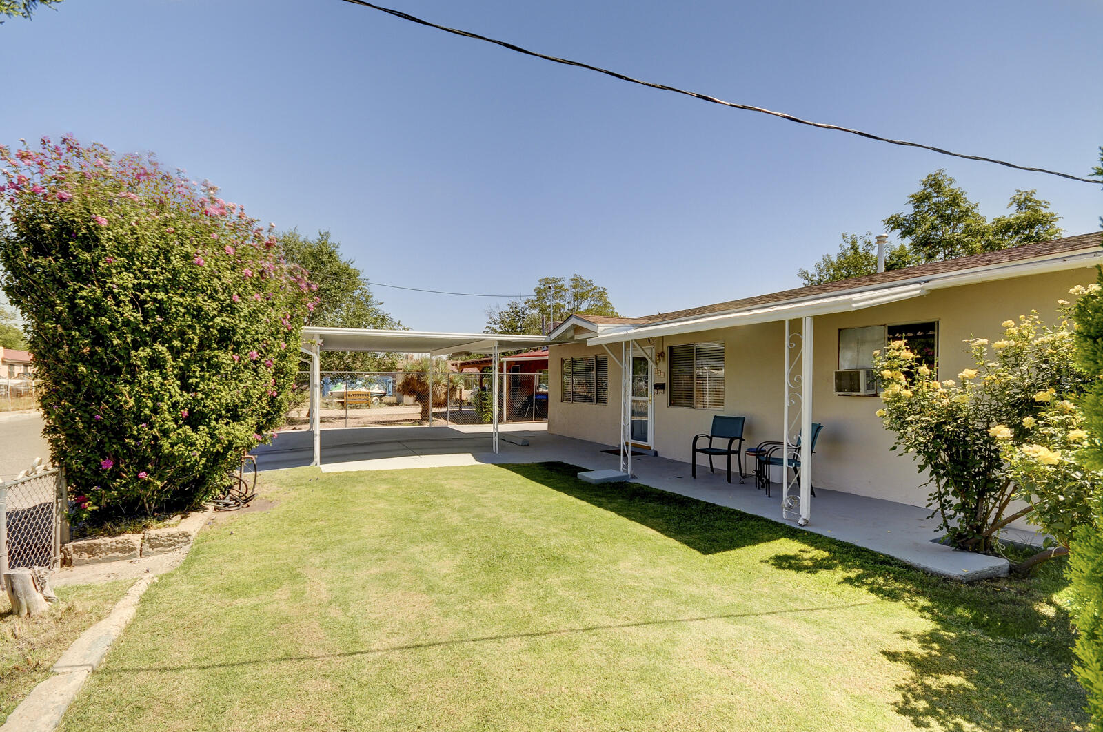 Fantastic Opportunity to Live in the Sought After North Valley!  Affordable and Charming 3 Bedroom 2 Bath home is ideally located in the Heart of the Valley!  Owner's suite boasts French Doors and private 3/4 Bath! Huge Living Room with Picture Windows!  Move In Condition with Excellent Potential to add Value by adding a few Updates and some TLC! Terrific Curb Appeal with Lush Green lawn!  Enjoy covered parking with a two-car carport, perfect for New Mexico's sunny days. Seller replaced the Roof 6 years ago, providing peace of mind!  Recent Furnace! Fresh Paint!  Home is sold as is, seller will not bear the cost for any repairs or updates. Great Value for the Area!  Location is a big plus! Close to shopping, restaurants, parks, downtown and UNM!