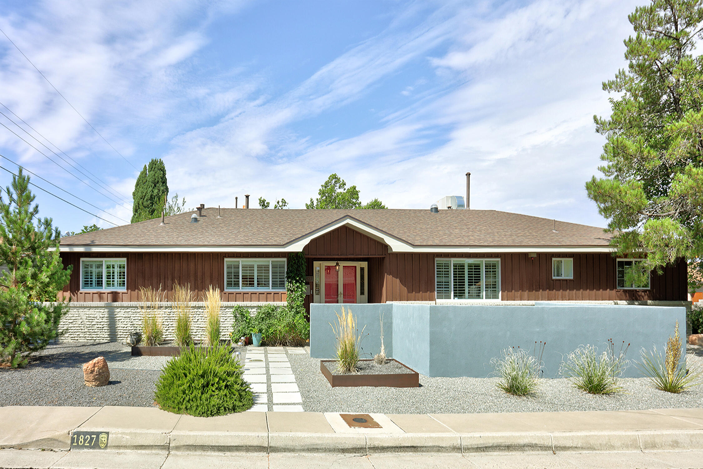 This Netherwood Park/UNM North Midcentury Ranch property is ideally located on a lush corner lot. Step through the double door entry into the great room with vaulted beam ceilings and original hardwood floors, and you know you are home. Four bedrooms with two primary suites, and two living spaces, both with fireplaces. There is room for everyone. Additional primary bedroom is separate from the rest of the house with a private entrance. Large kitchen with tons of granite counters and cabinets. A heated sunroom looks out to the private back yard would make an ideal office or flex room. Ample storage with three walk-in closets. Lots of outdoor spaces to enjoy including the back covered patio off the beautiful green lawn, and front courtyard. Professional landscaping with mature trees.