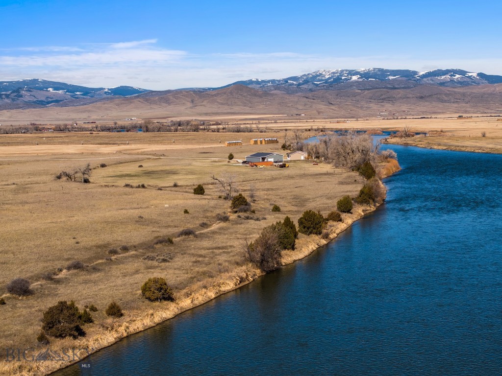 Don't miss this once-in-a-lifetime opportunity to own a piece of RARE Riverfront acreage on the iconic Missouri River under the big sky of Montana! Originally homesteaded in the 1880's, this property has never before been offered for sale. Imagine yourself enjoying outdoor water recreation with over 2,000 feet of frontage along the Missouri River for your personal direct access to the water for fishing and boating. With over 34 level and usable acres, the possibilities for future uses are as wide open as your imagination, desires, and specialty real estate needs. This property, situated at the intersection of two Montana state highways and with no covenants or zoning restrictions, offers the new landowner so many options....recreational, residential, agricultural, or commercial! Recreationally, you'll enjoy unwinding while fishing from your own riverbank and putting your drift boat in at the boat ramp right across the road. Residentially, live your dream and create memories that last a lifetime by building your legacy Montana getaway or even a family compound for generational living. Agriculturally, there is ample room to "live off the land" and supplement your personal food bills or provide "locally grown" farm-to-table for the surrounding communities and businesses. Commercially, this acreage is situated in a highly desirable highway corridor halfway between I-90 and I-15. Some possible uses might include a fishing guide lodge and supply store, glamping, hotel, boat/RV storage, agriculture or landscaping storage or transfer station, or any other highway commerce uses. If you need more than this Missouri riverfront 34+ acre parcel, the property right across the road is also for sale. Big picture buyers or investors might want to combine this riverfront parcel with the 17+ acre commercially improved parcel offering four enclosed dry storage buildings, an open-storage structure, and an office.  Your opportunity lies ahead to own this rare Montana gem conveniently located about 45 minutes from the vibrant and picturesque community of Bozeman which is home to the Bozeman Yellowstone International Airport, and also about 45 minutes from Montana's historic capital city of  Helena. The time to act is now!
