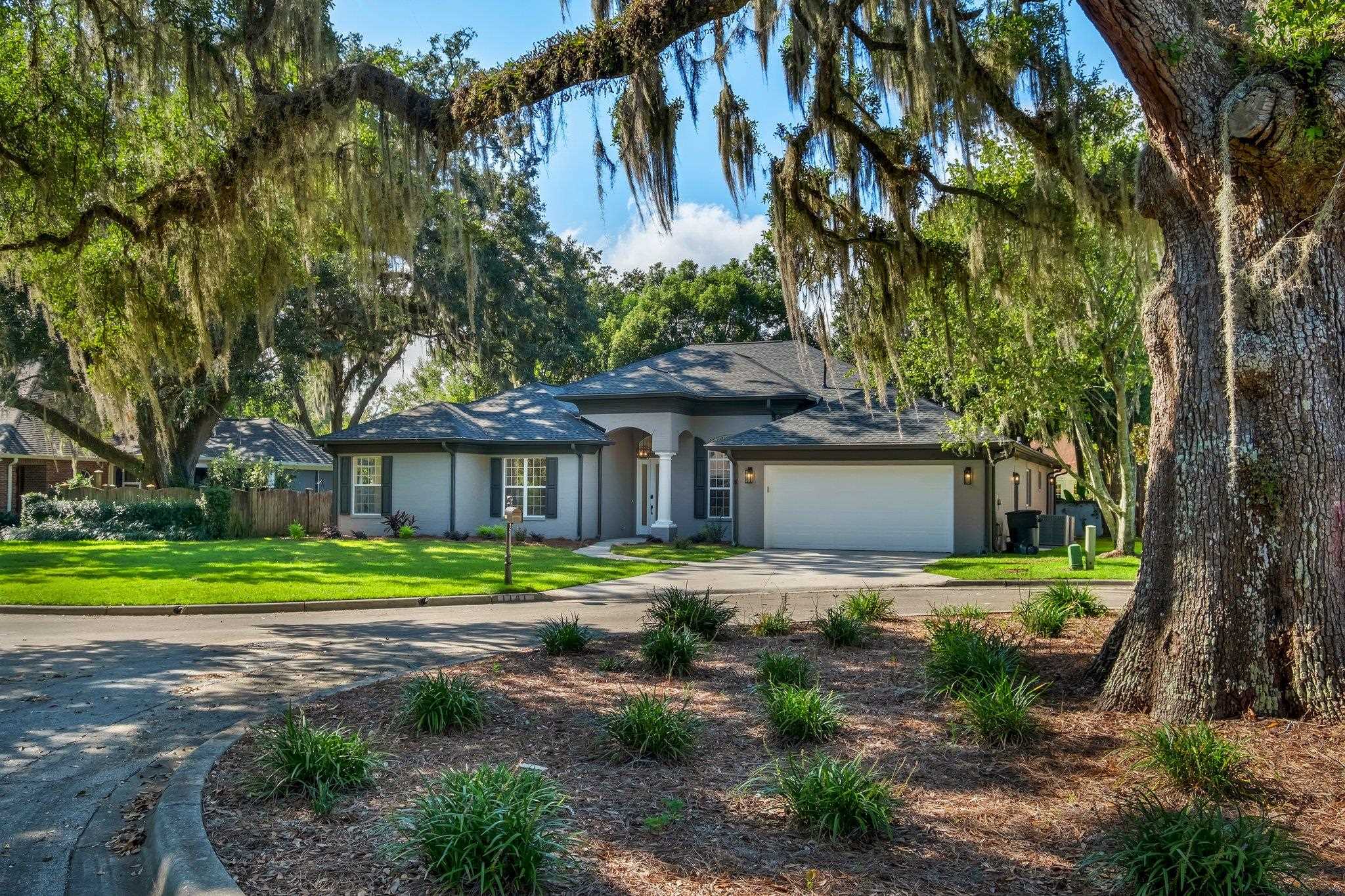 Stunning 4 bedroom 3 bath home located along the coveted Thomasville Road corridor across from Tallahassee Nurseries. Appraised for $880,000 in September 2024.  This residence offers the perfect blend of luxury, comfort and convenience.  Completely renovated inside and out, the home features a posh expansive kitchen and multiple living areas, providing ample space for family gatherings and entertaining.  Massive family room/den with skylights.  Kitchen features a generous island, quartz countertops, pendant lighting, cabinets with soft close drawers, gas cooktop and double oven.  10-12 ft ceilings throughout, separate office/study, beautiful gas fireplace, LVP flooring, stylish lighting, ceiling fans with remotes, and impressively remodeled modern bathrooms.   Solid wood shelving throughout. Two bedrooms (1 with designated entry from outside) and a bathroom can be separated from main house with a pocket door.  Perfect for in-laws, college students, or extended family visits.  2-car garage is climate controlled and has an electric charging plug for your electric car and/or collectible.  Also includes a generator charging plug power outlet box.  Laundry room with sink and brand new washer and dryer.  Low maintenance yard for busy professionals with families.