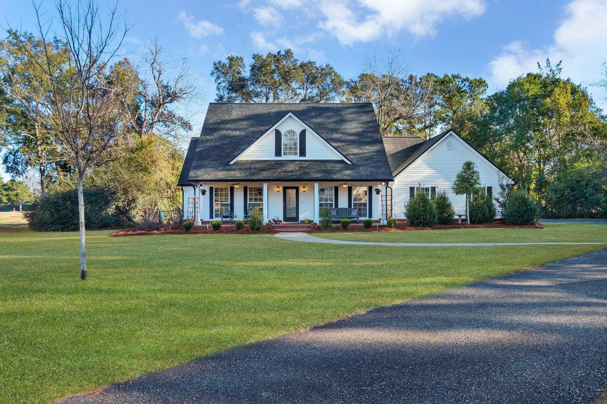 Charming, meticulously maintained 3-bedroom, 3-bath home located in desirable Country Club Estates on Havana Golf Course. This house features a welcoming rocking chair front porch with brick paver floor, enhancing its amazing curb appeal.  Inside, you'll be greeted by an inviting foyer and will find an open concept kitchen and living area complete with a cozy wood-burning fireplace.  There is also a separate dining room that overlooks the front porch.  Split paln for privacy.  The primary bedroom is private and roomy with a walk in closet, double sinks and tile shower.  Enclosed back porch area offers a versatile flex space, currently used as a study and a bar and reading/TV nook.  There's also a conveniently located half bath within steps of back patio.  Other features are a large, fenced backyard with direct golf course access.  Recent updates include new roof, HVAC, and refrigerator in 2024!  Water heater recent.  New gutters added during ownership.  All measurements are approximate, buyer to verify.