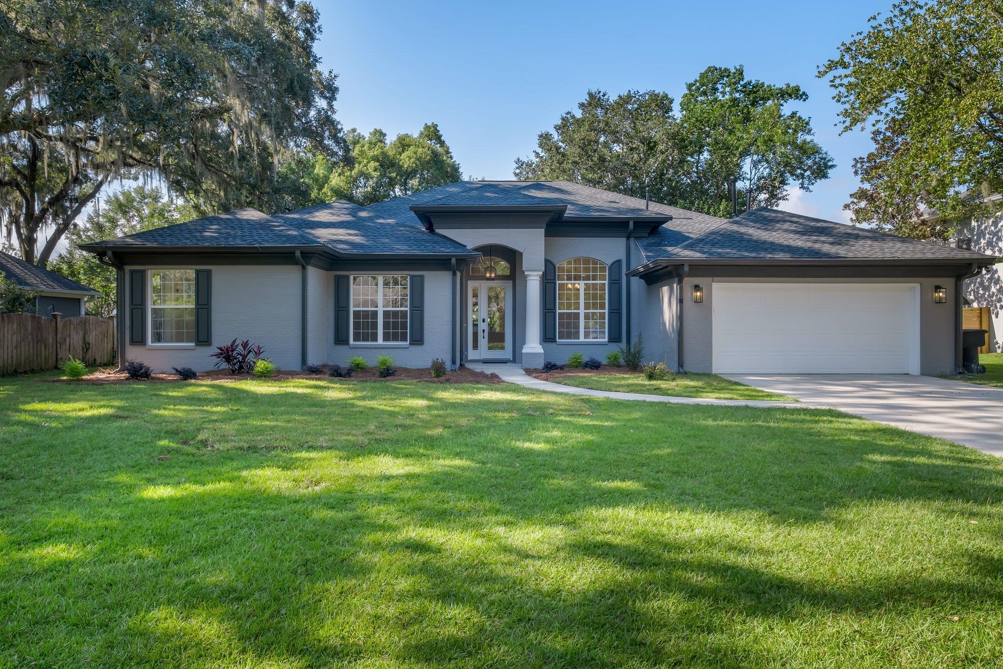 Stunning 4 bedroom 3 bath all brick home located along the coveted Thomasville Road corridor across from Tallahassee Nurseries. Appraised for $880,000 in September 2024.  This residence offers the perfect blend of luxury, comfort and convenience.  Completely renovated inside and out, the home features a posh expansive kitchen and multiple living areas, providing ample space for family gatherings and entertaining.  Massive family room/den with skylights.  Kitchen features a generous island, quartz countertops, pendant lighting, cabinets with soft close drawers, gas cooktop and double oven.  10-12 ft ceilings throughout, separate office/study, beautiful gas fireplace, LVP flooring, stylish lighting, ceiling fans with remotes, and impressively remodeled modern bathrooms.   Solid wood shelving throughout. Two bedrooms (1 with designated entry from outside) and a bathroom can be separated from main house with a pocket door.  Perfect for in-laws, college students, or extended family visits.  2-car garage is climate controlled and has an electric charging plug for your electric car and/or collectible.  Also includes a generator charging plug power outlet box.  Laundry room with sink and brand new washer and dryer.  Low maintenance yard for busy professionals with families.